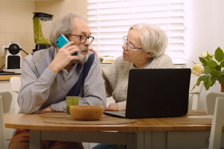 Older couple talking on phone about federal retirement